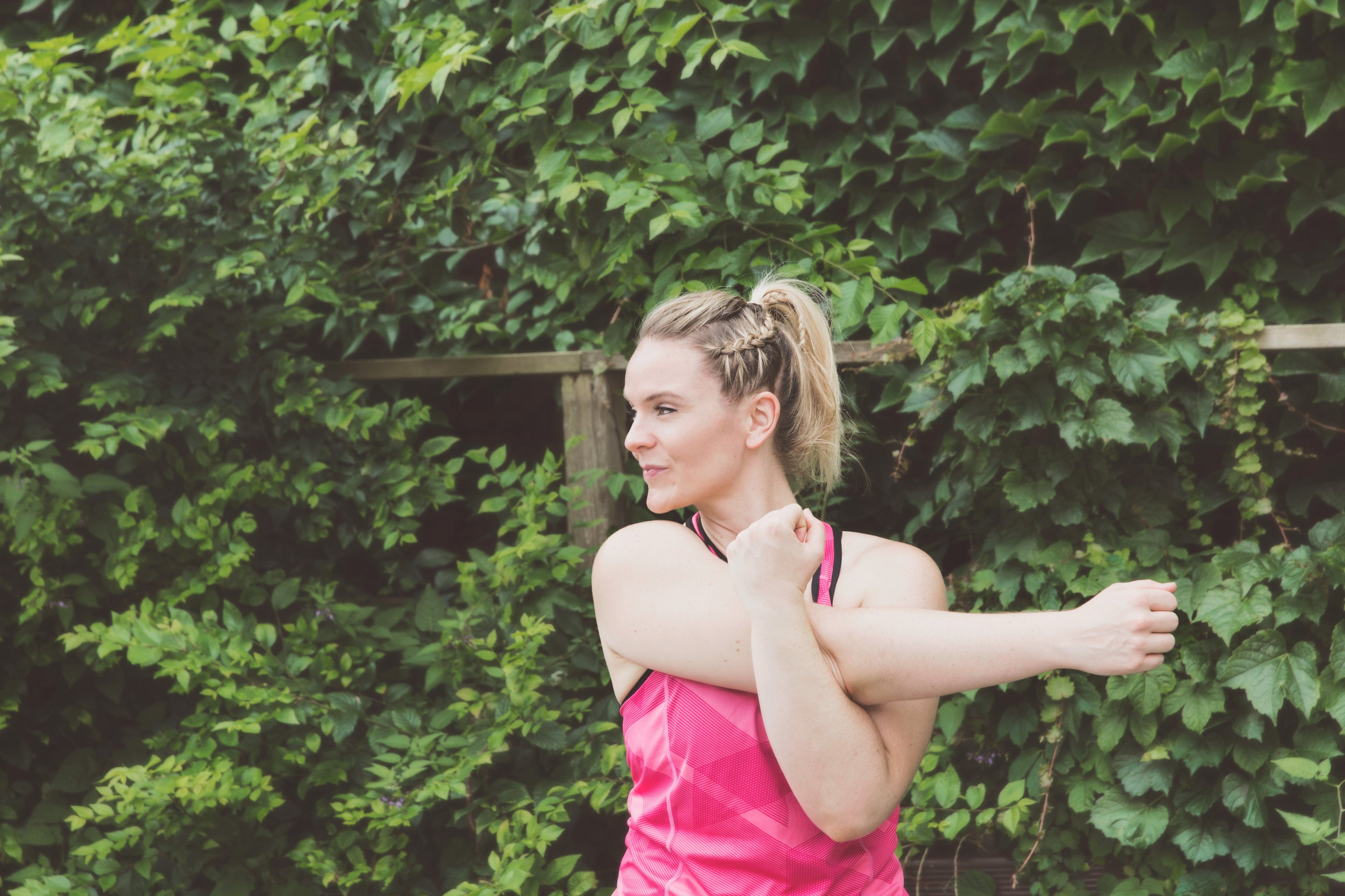 A woman stretching and smiling she's no longer in pain.